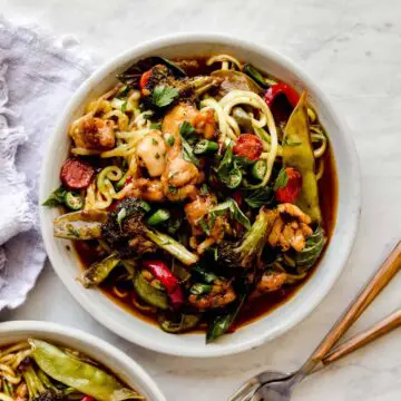 bowl of whole30 drunken noodles and zucchini with forks on the side