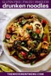 drunken zucchini noodles on a white plate topped off with fresh basil