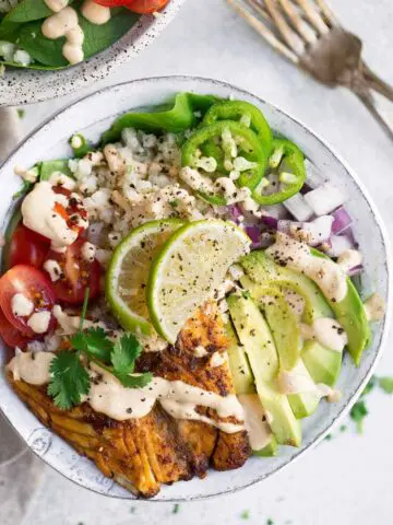 This recipe for Whole30 Fish Taco Bowls will leave you wanting more! Healthy whole30 fish taco bowl that is served on a bed of lettuce and cauliflower rice, topped off with a creamy chipotle sauce! Only 10 minutes to prepare! whole30 meal plan. Easy whole30 dinner recipes. Whole30 recipes. Whole30 lunch. Whole30 meal planning. Whole30 meal prep. Healthy paleo meals. Healthy Whole30 recipes. Easy Whole30 recipes. Easy whole30 dinner recipes...