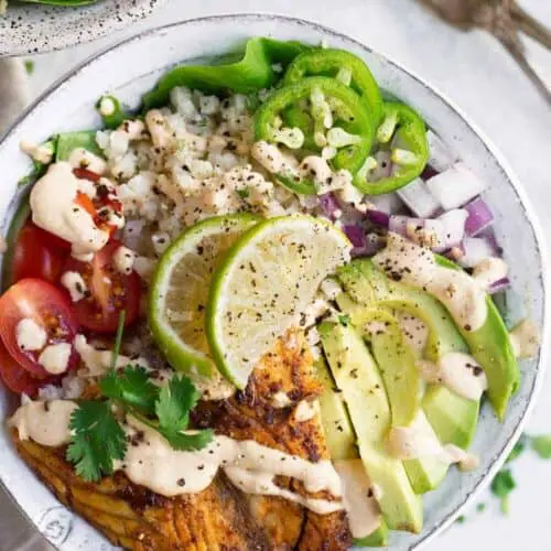 This recipe for Whole30 Fish Taco Bowls will leave you wanting more! Healthy whole30 fish taco bowl that is served on a bed of lettuce and cauliflower rice, topped off with a creamy chipotle sauce! Only 10 minutes to prepare! whole30 meal plan. Easy whole30 dinner recipes. Whole30 recipes. Whole30 lunch. Whole30 meal planning. Whole30 meal prep. Healthy paleo meals. Healthy Whole30 recipes. Easy Whole30 recipes. Easy whole30 dinner recipes...