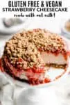 strawberry cheesecake on a white cake stand with oat crumble