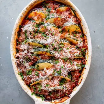low carb zucchini casserole with red sauce and parmesan cheese on top