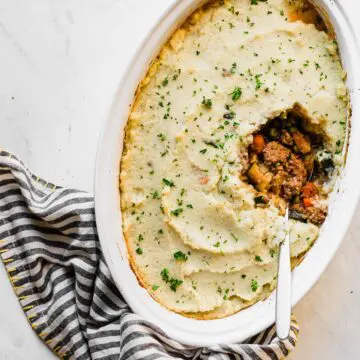 keto shepherd's pie in a white pan with a spoon inside