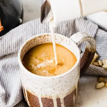 french vanilla creamer made with cashews being poured into coffee mug
