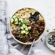 hawaiian poke bowl topped with avocado, cucumber and seaweed