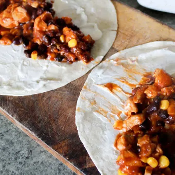 My kids go crazy for these! Simple chicken and black bean enchiladas.