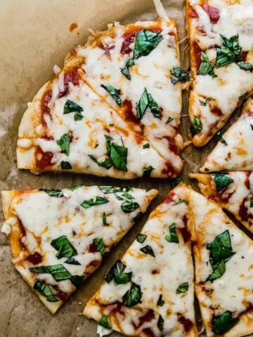 gluten free cheese pizza on brown parchment paper