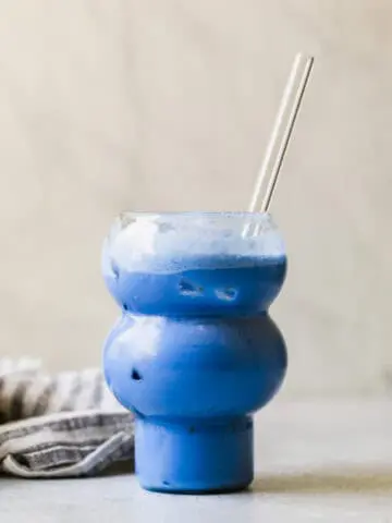 star wars blue drink in a glass with a glass straw in it