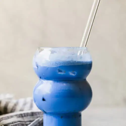 star wars blue drink in a glass with a glass straw in it