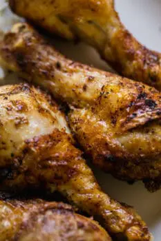 air fryer drumsticks together on a white plate