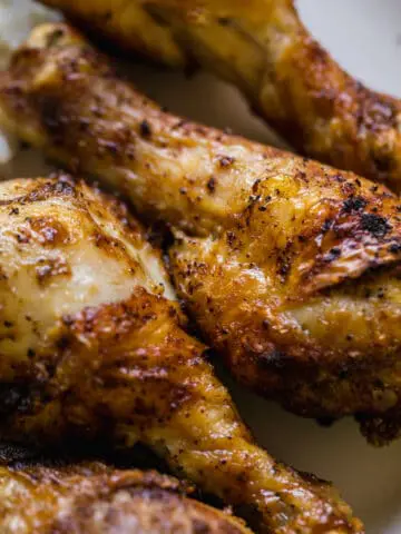 air fryer drumsticks together on a white plate