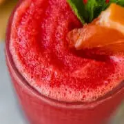 frozen watermelon paloma garnished with mint and a watermelon wedge