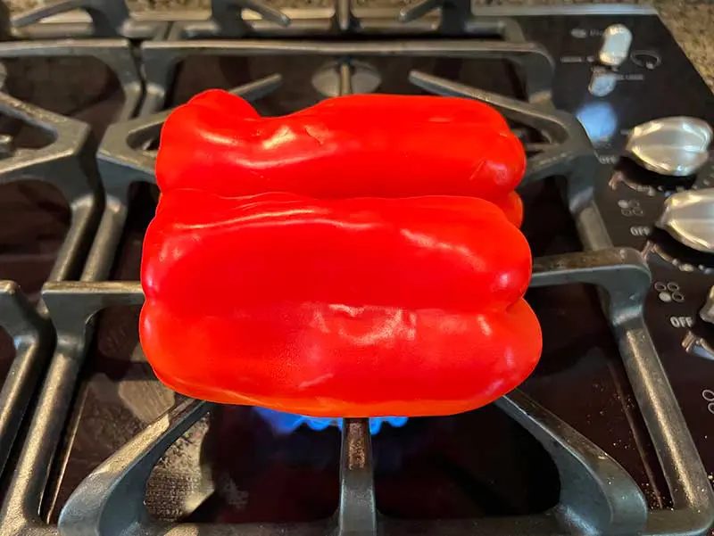Raw bell pepper placed on stove flame
