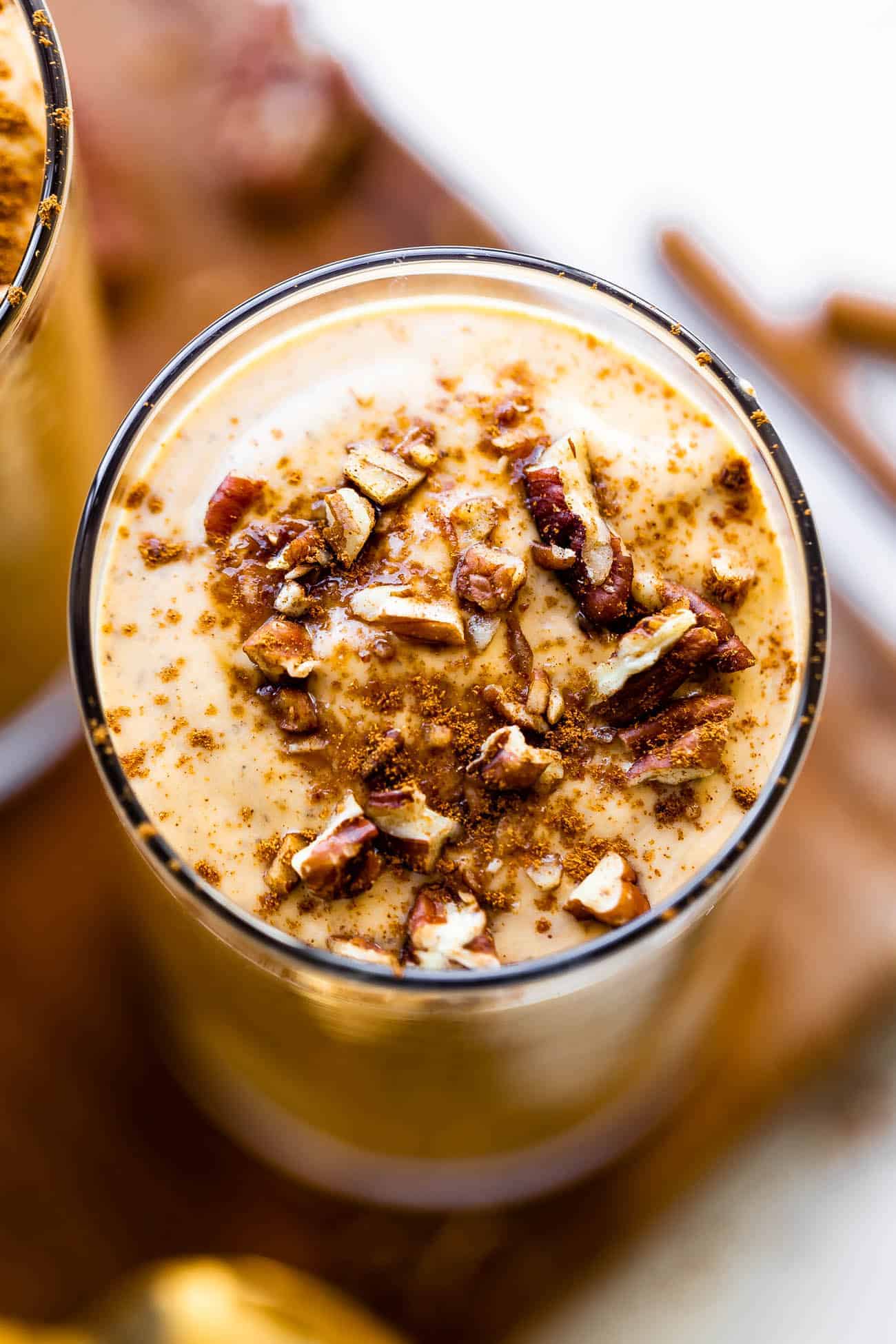 close up of dairy free pumpkin shake with pecans and coconut sugar