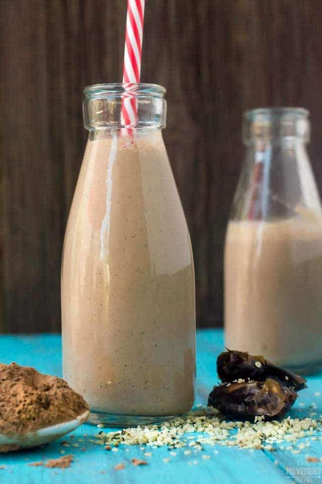 Chocolate Hemp Milk in a two glass next to cacao powder