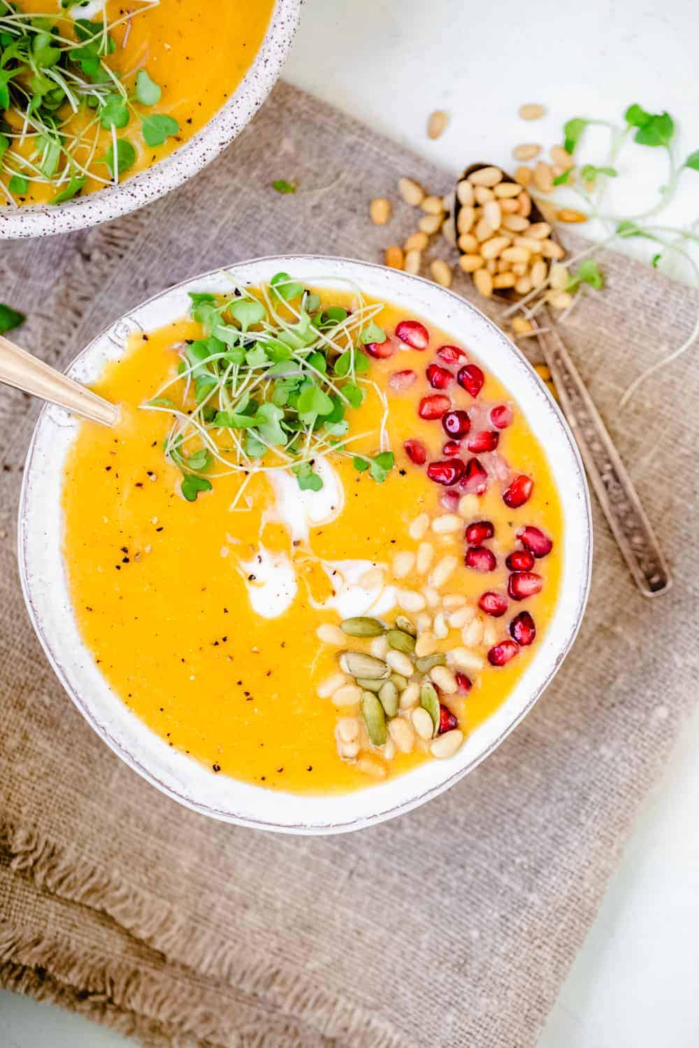 roasted butternut squash soup in two white bowls