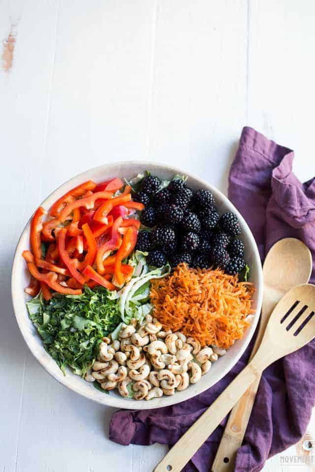 Whole30 Thai Breakfast Bowl of peppers, carrots, nuts, kale, napa cabbage and blackberries