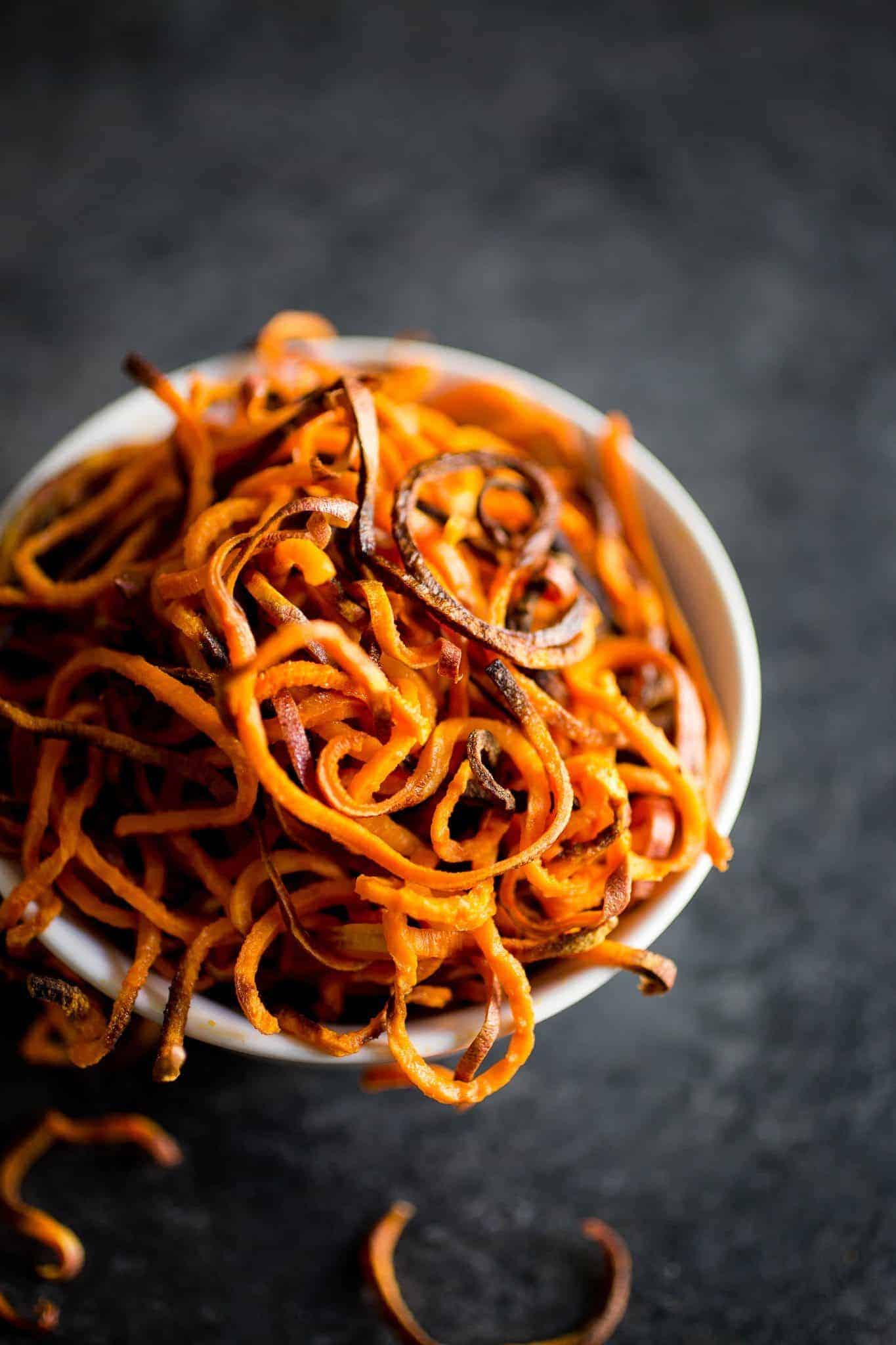 spiralized sweet potato fries in a white bowl