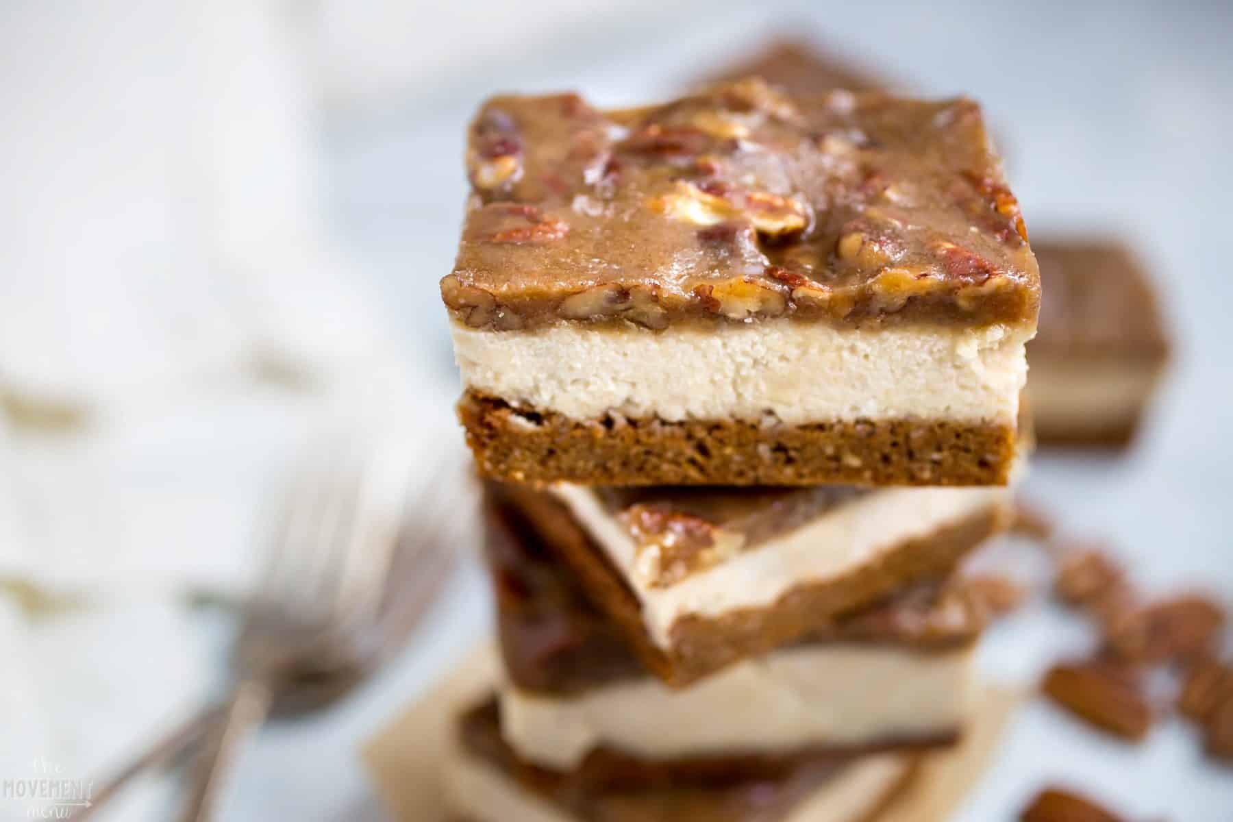 Paleo pecan caramel cheesecake bars with two forks