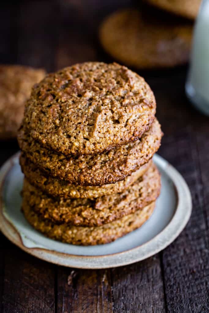 gluten free gingerbread cookies stacked high on a plate