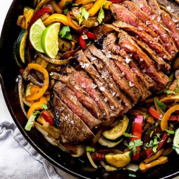 steak fajitas in a cast iron pan