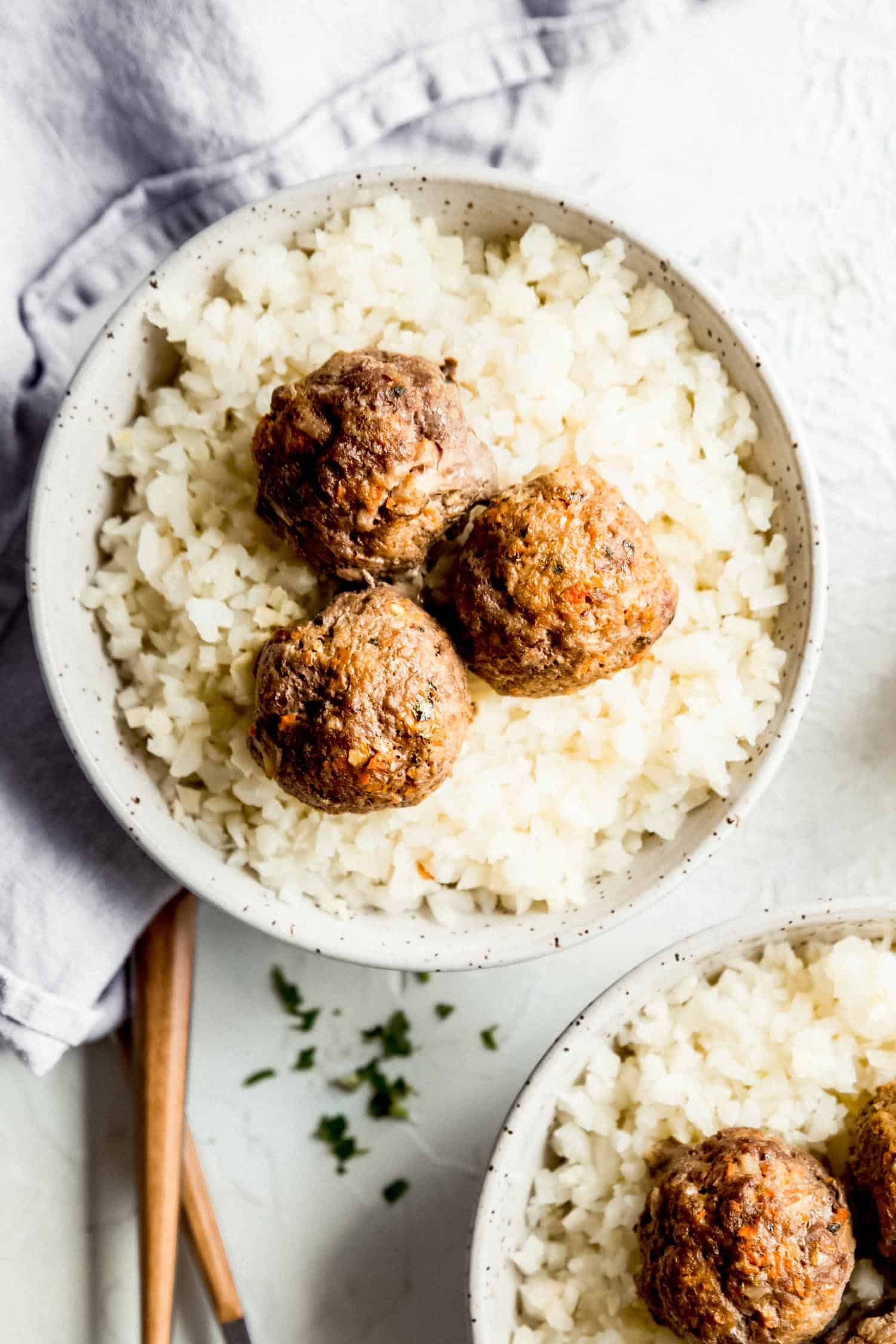 whole30 meatballs in a bowl with cauliflower rice