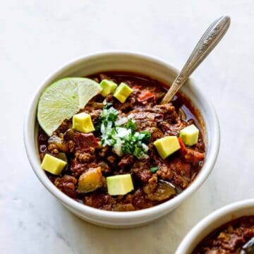 low carb and whole30 chili in a bowl with a lime wedge and spoon inside