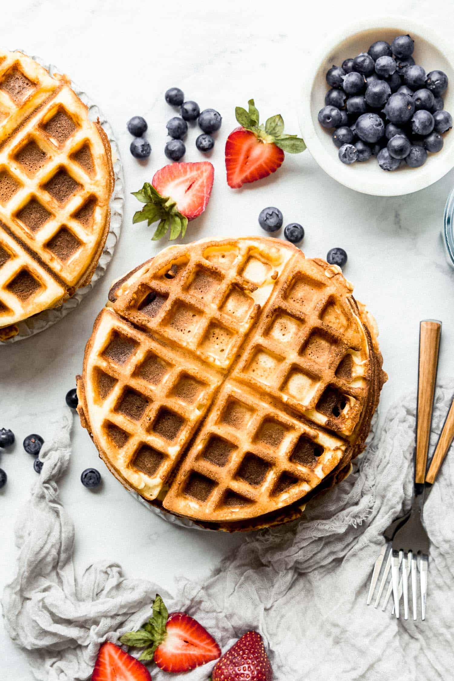 plain paleo waffles on a plate with blueberries on the side