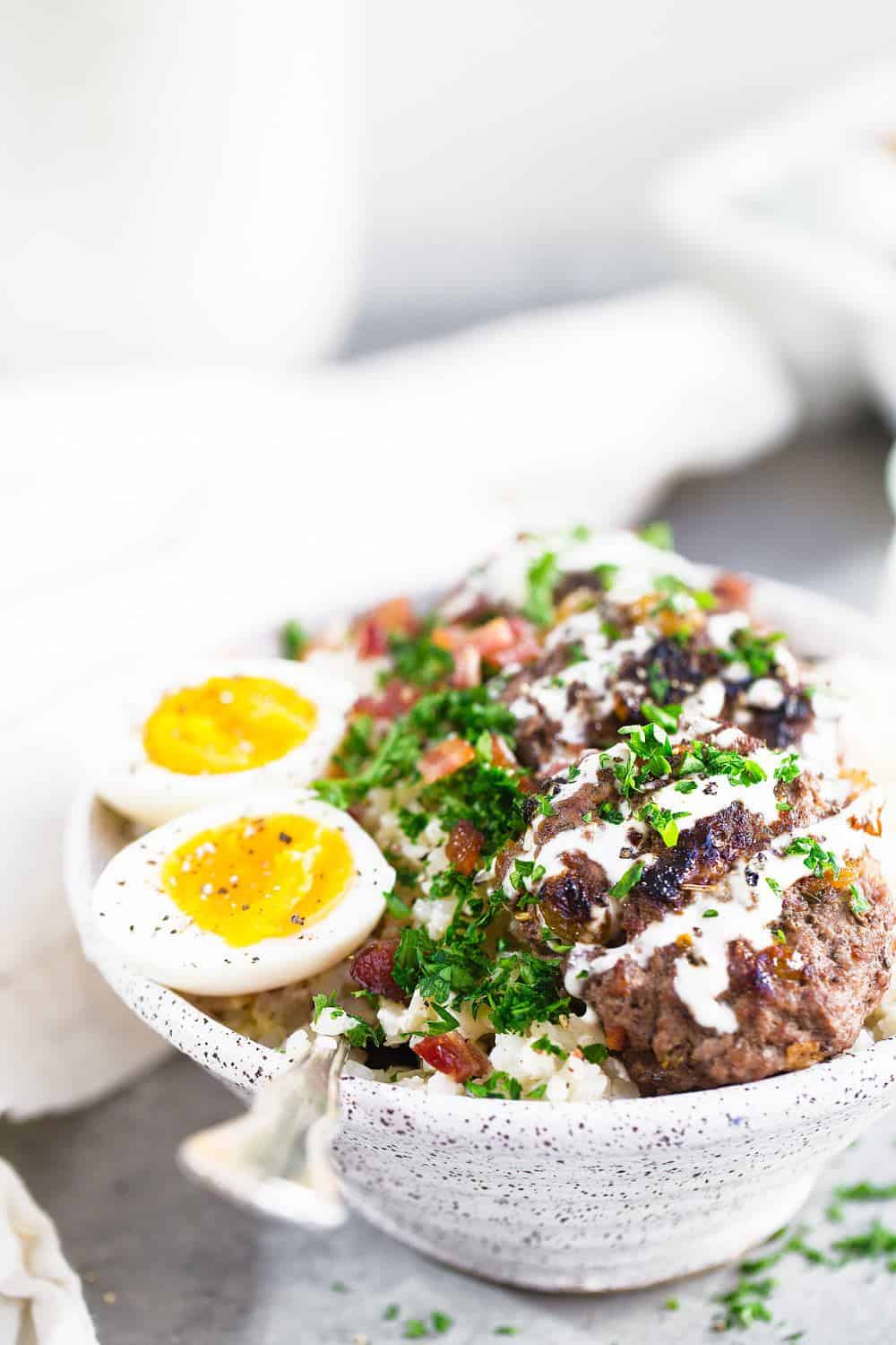 Whole30 Beef and Bacon Breakfast Bowl with a soft boiled egg