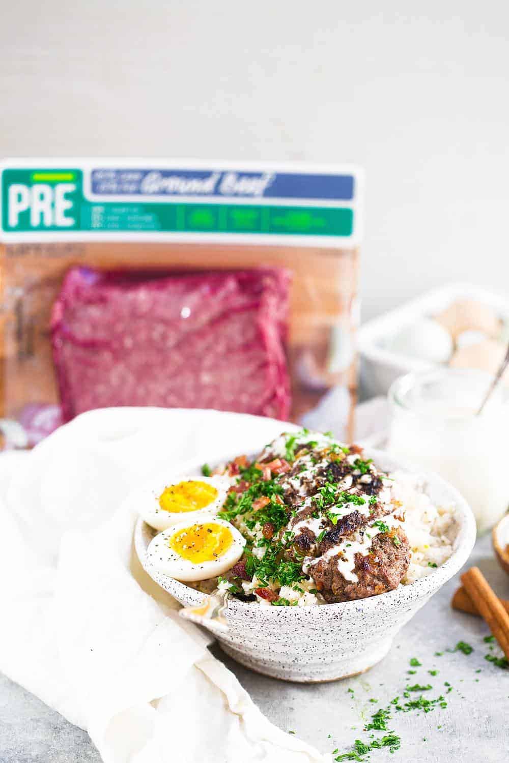 Whole30 Beef and Bacon Breakfast Bowl with ground beef in the background