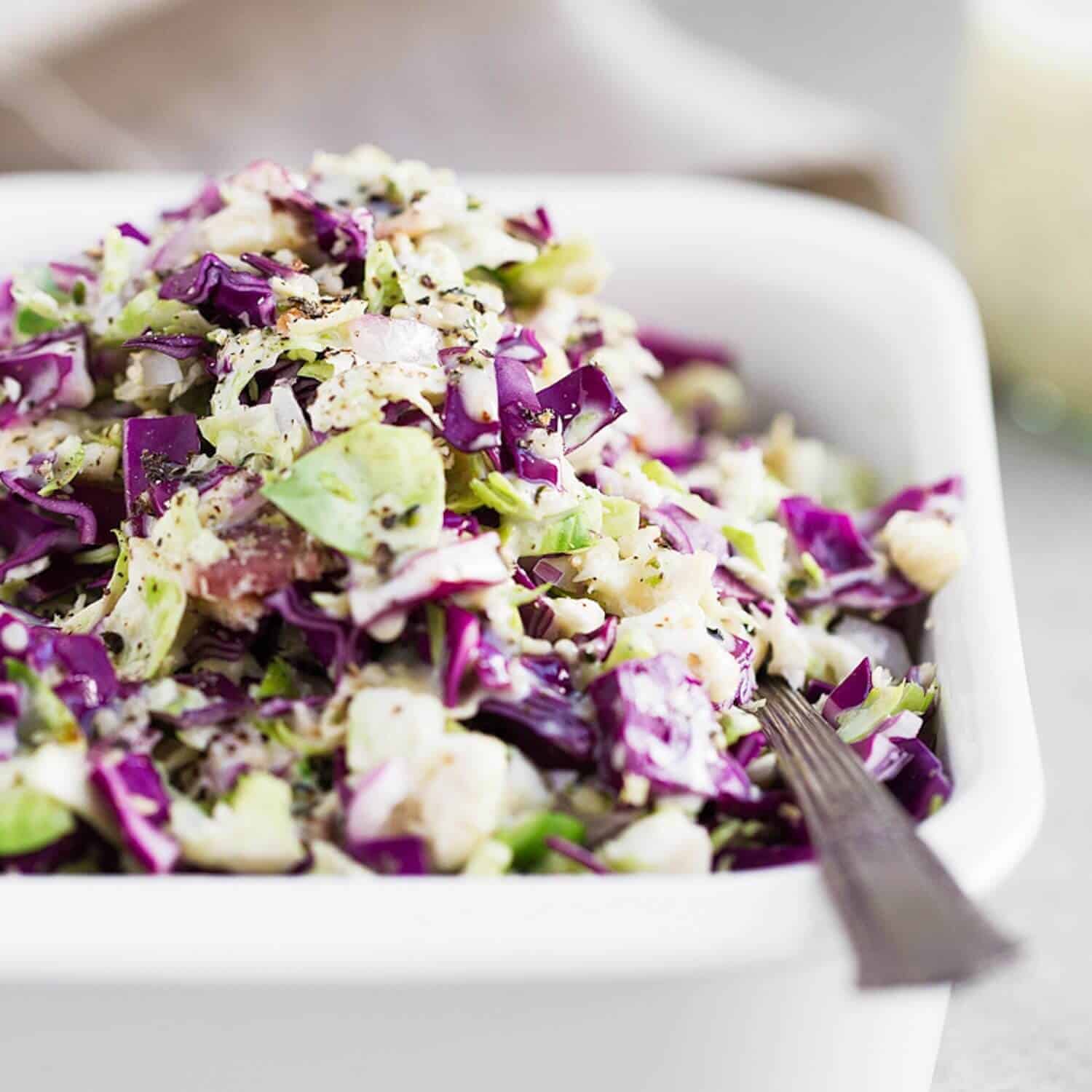 Whole30 Brussels Sprout Slaw recipe. The BEST brussels sprout slaw made with bacon, cabbage and hemp seeds! Low carb paleo brussels sprout slaw. Low carb side dishes. Whole30 side dishes. Best whole30 recipes. Whole30 Brussels and bacon. Brussels sprout bacon recipe. Low carb brussel sprout recipes. Healthy brussel sprout salad. Whole30 lunch recipes.