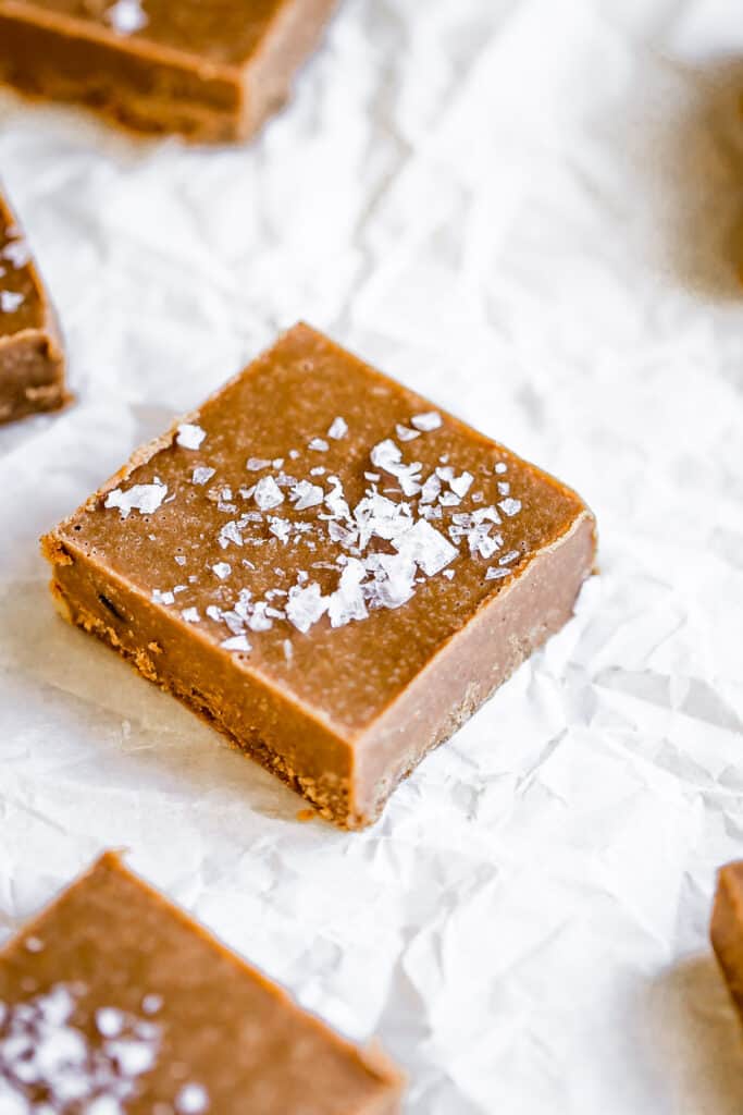 dairy free fudge with flaked salt on top of parchment paper