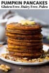 pumpkin pancakes on a white plate with butter on top and a fork