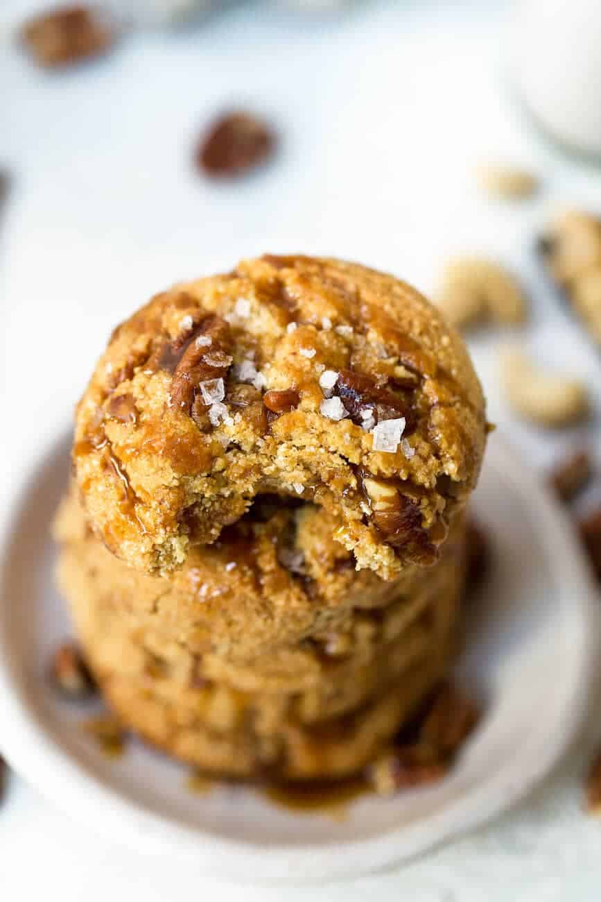Salted caramel pecan cookies with a small bite missing out of one