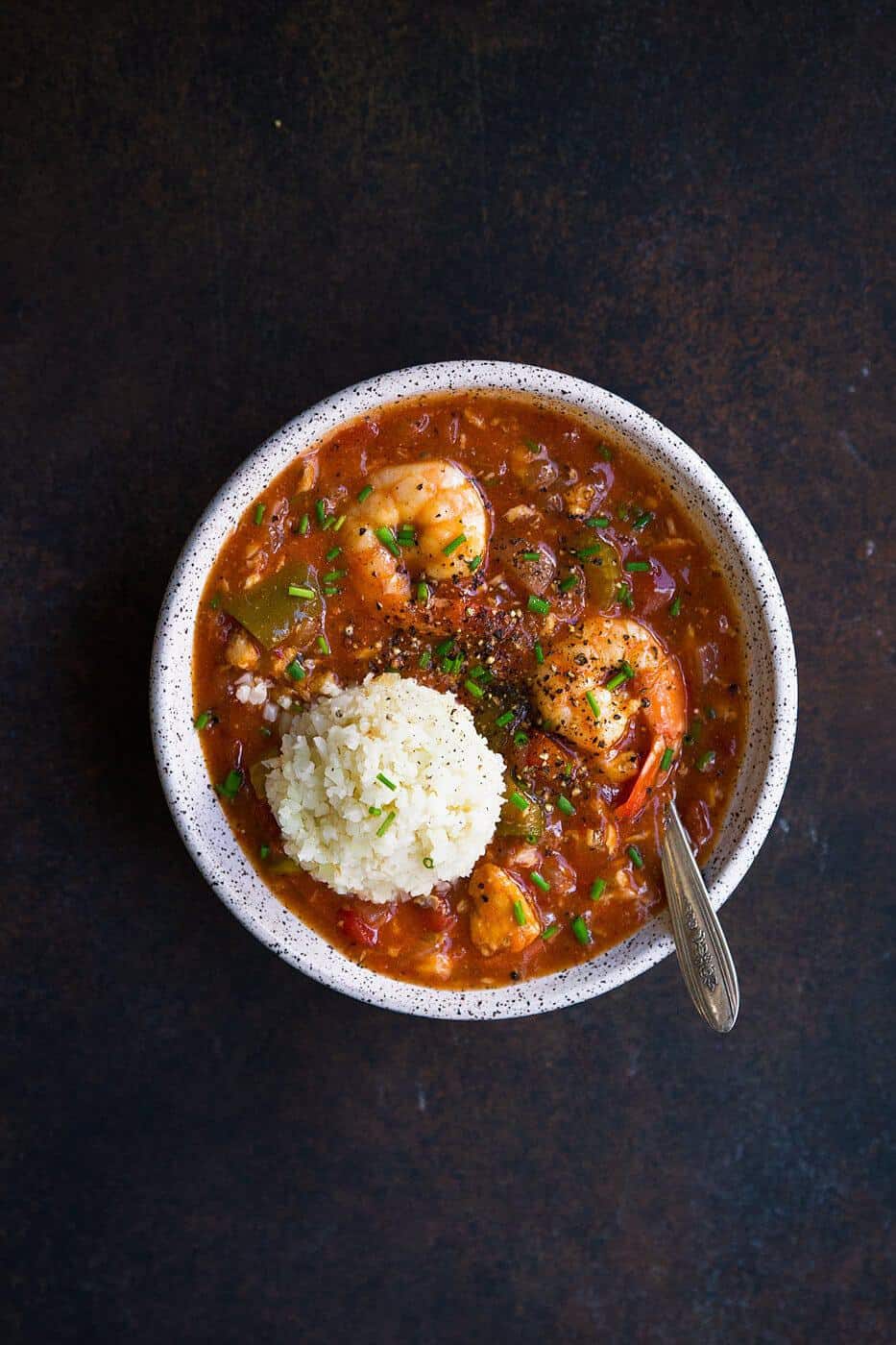 overhead shot of seafood gumbo in a bowl with rice