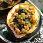 Apple and Sausage Stuffed Acorns Squash is the perfect Thanksgiving dish and recipe to be eating all fall and winter long. It's filled with pork sausage, dried cherries, apples and pecans. Topped off with fresh herbs and absolutely delicious! Sausage stuffed acorn squash. Paleo acorn squash recipe. Sausage stuffed squash recipe.