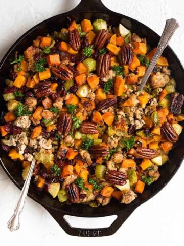 Gluten Free Stuffing recipe that is full of nutrient dense vegetables and topped off with toasted pecans and dried cranberries. It can be made vegan as well if you omit the sausage. Gluten free stuffing recipe. Grain free stuffing recipe. Paleo thanksgiving recipes.