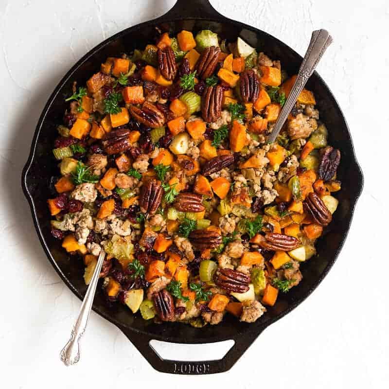 Gluten Free Stuffing recipe that is full of nutrient dense vegetables and topped off with toasted pecans and dried cranberries. It can be made vegan as well if you omit the sausage. Gluten free stuffing recipe. Grain free stuffing recipe. Paleo thanksgiving recipes.