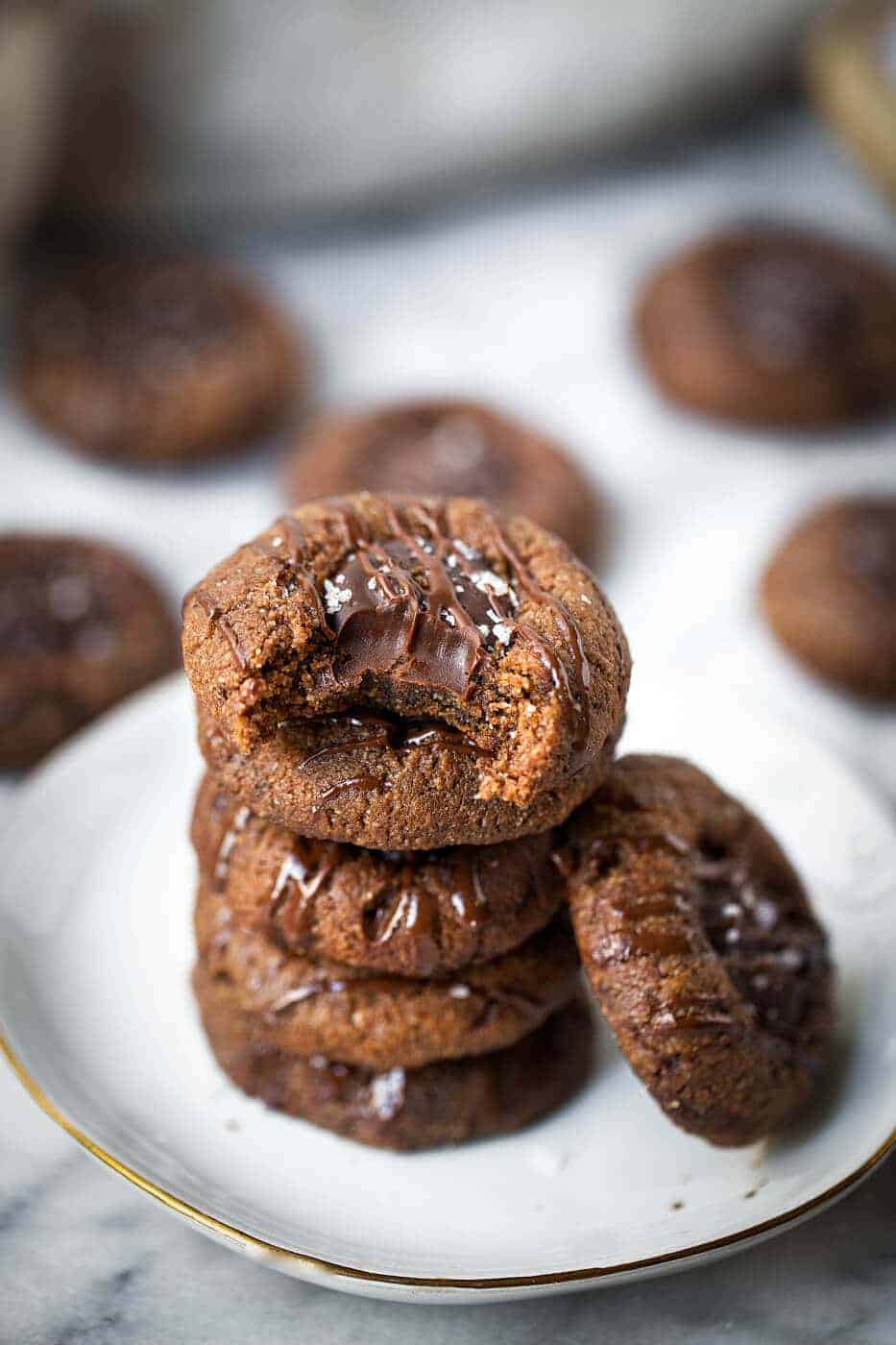 Double Chocolate Vegan Thumbprint Cookies stacked in a pile on a plate