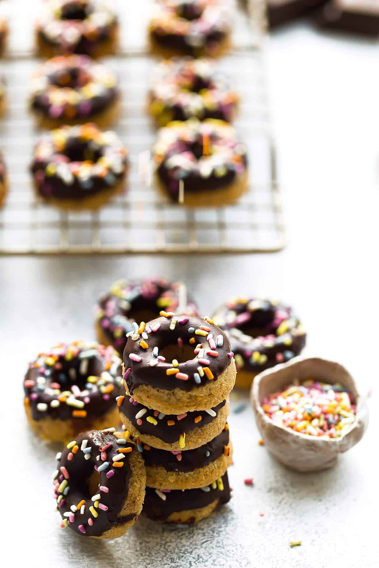 A batch of Mini Paleo Donuts with sprinkles