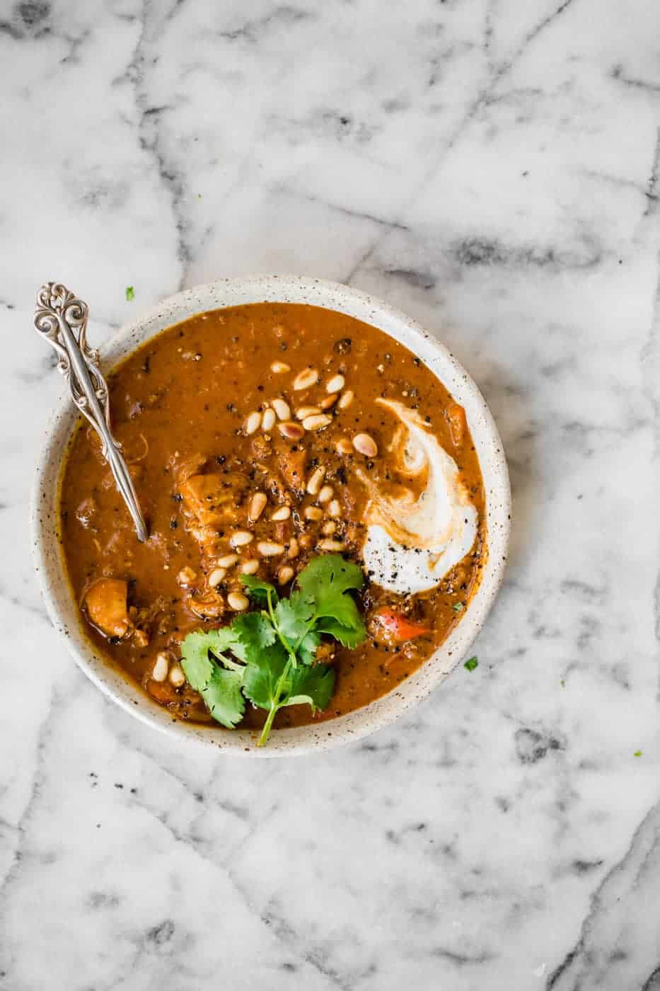 Whole30 Chicken Korma in a bowl with a spoon