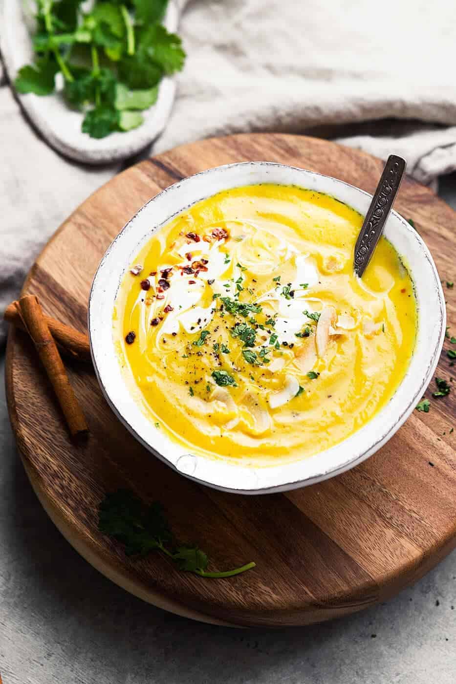 Whole30 Golden Milk Soup in a bowl on a wooden board