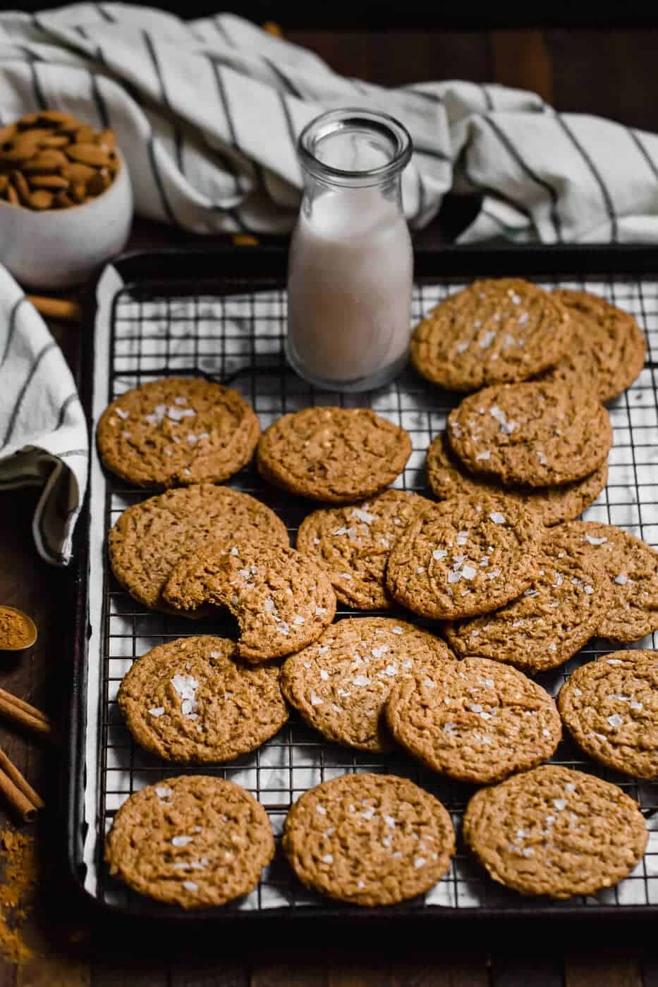 almond butter cookies on a wire rack with sea salt on top