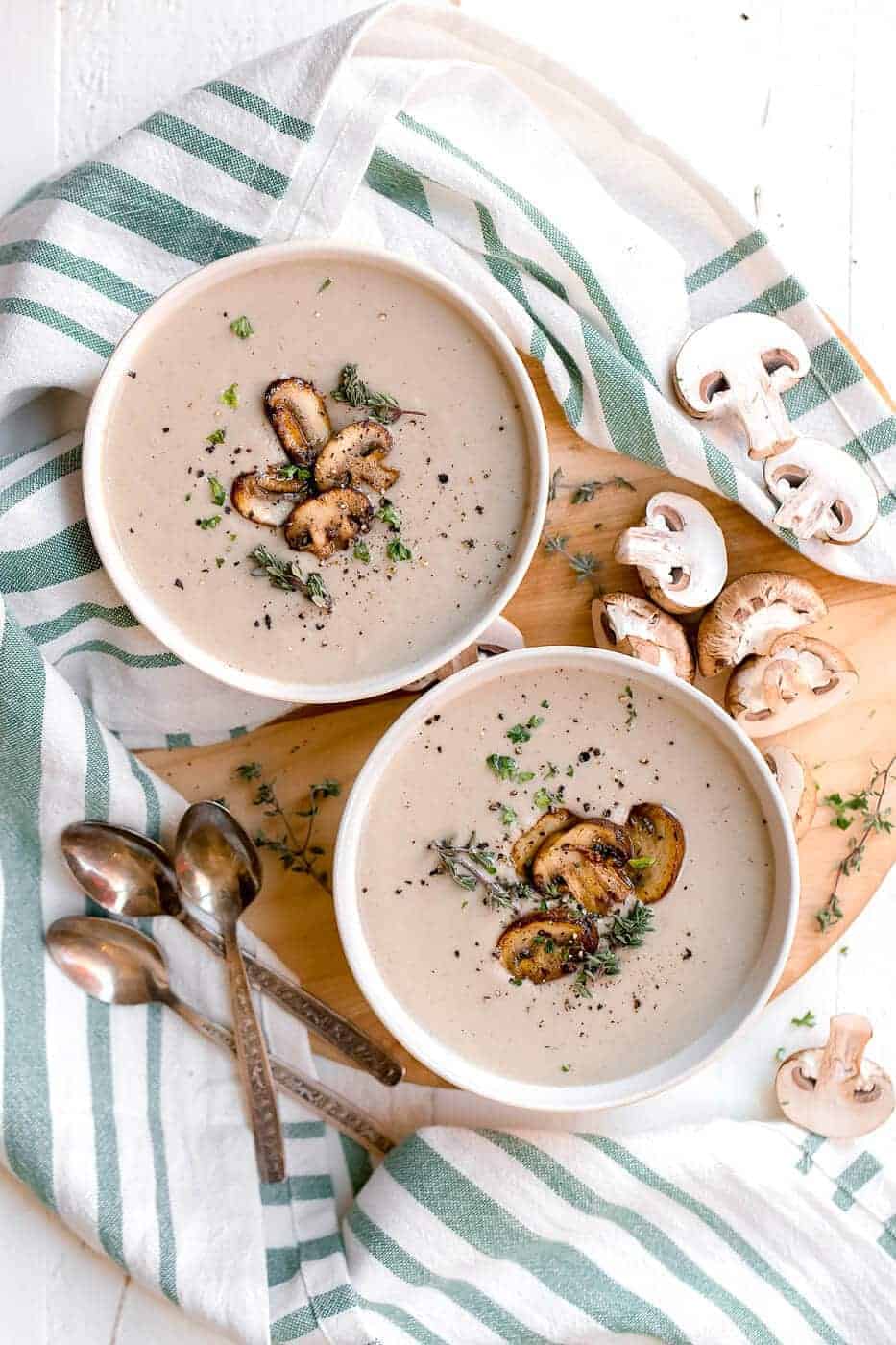 Cream of Mushroom Soup in two bowls with slice mushrooms