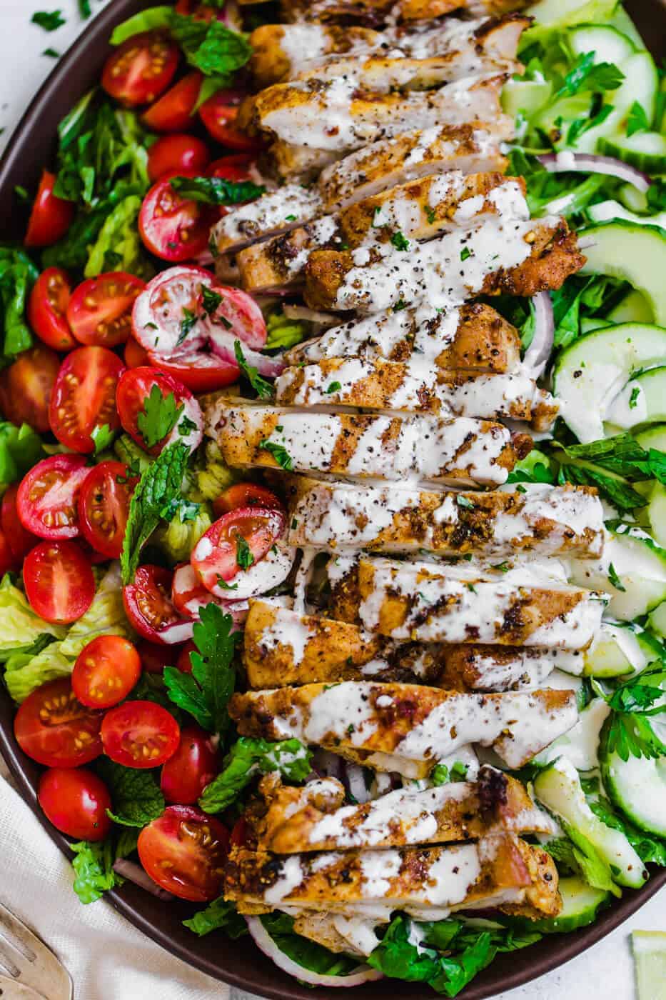 Spiced chicken in a serving dish with salad