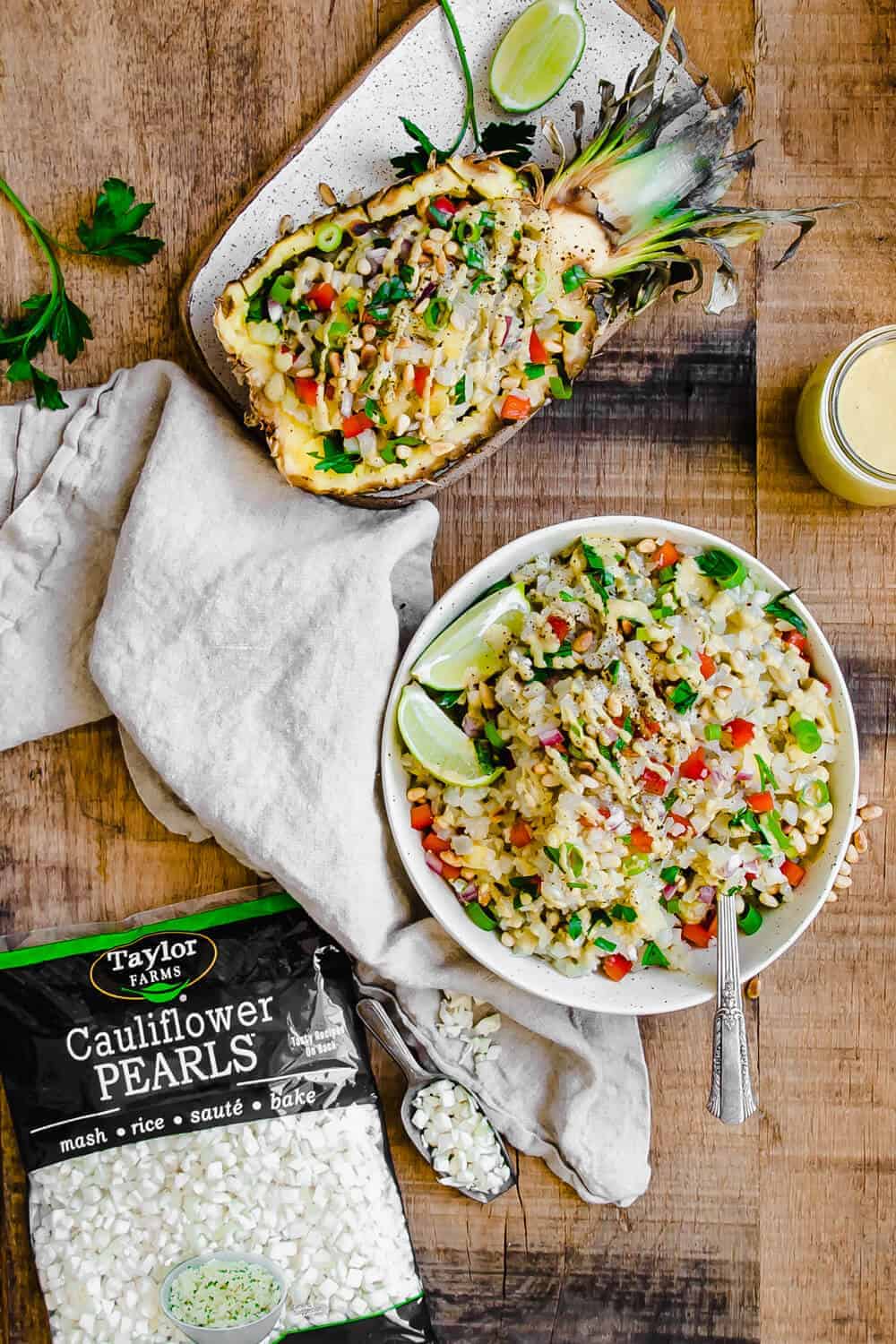 Thai Cauliflower Rice Salad on a sliced pineapple and in a white bowl