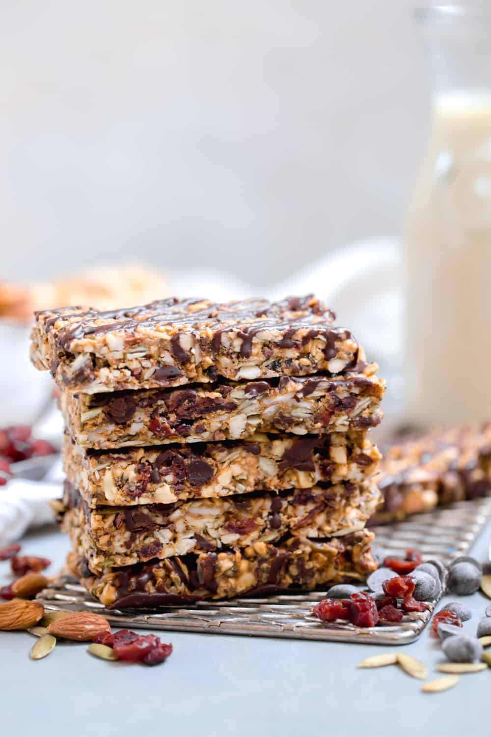 Paleo Granola Bars stacked in a pile with seeds, nuts and dry fruits