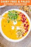 bowl of butternut squash soup with pomegranate and micro greens
