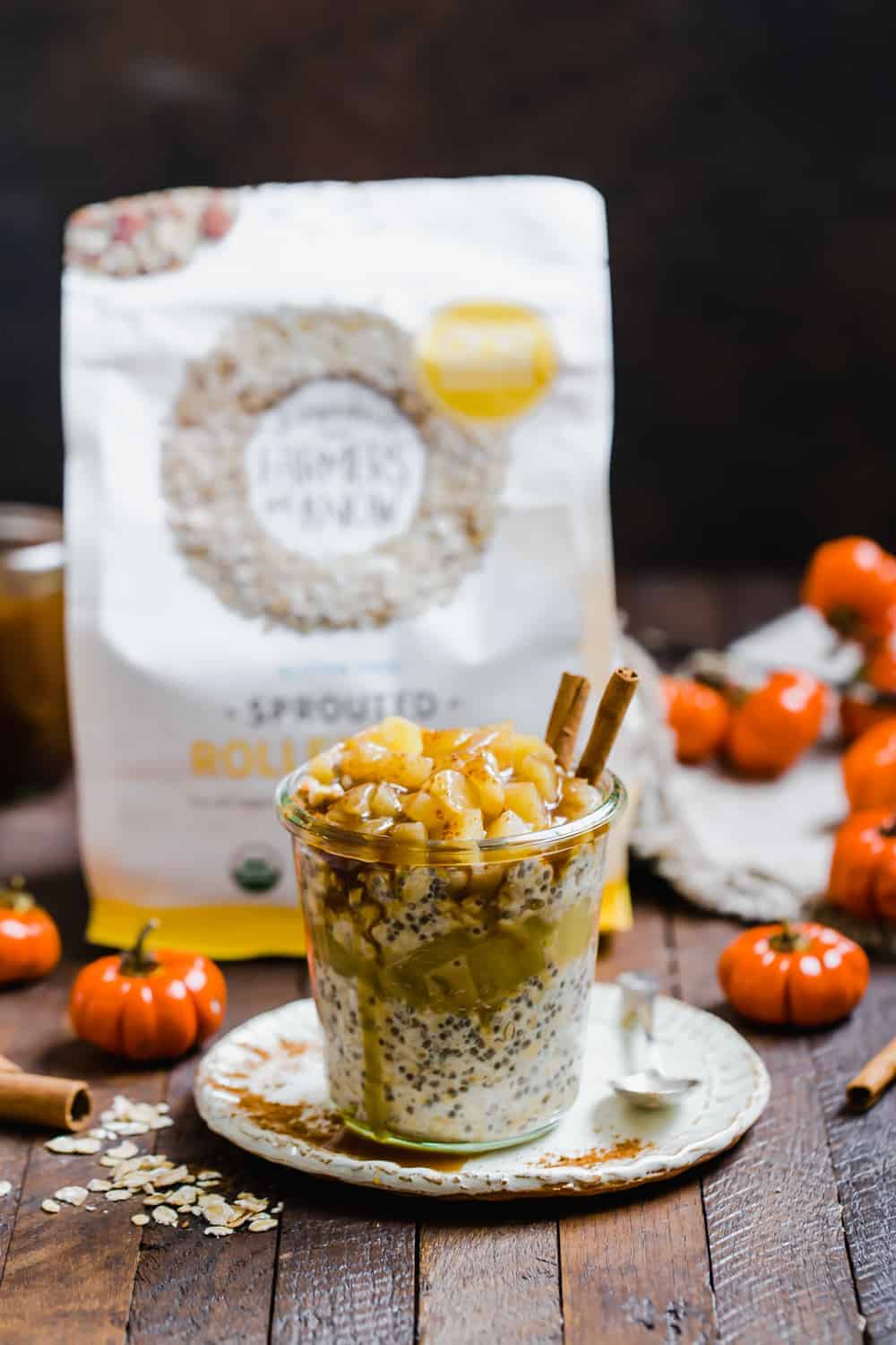 Pumpkin pie overnight oats in a glass jar on a plate with a spoon