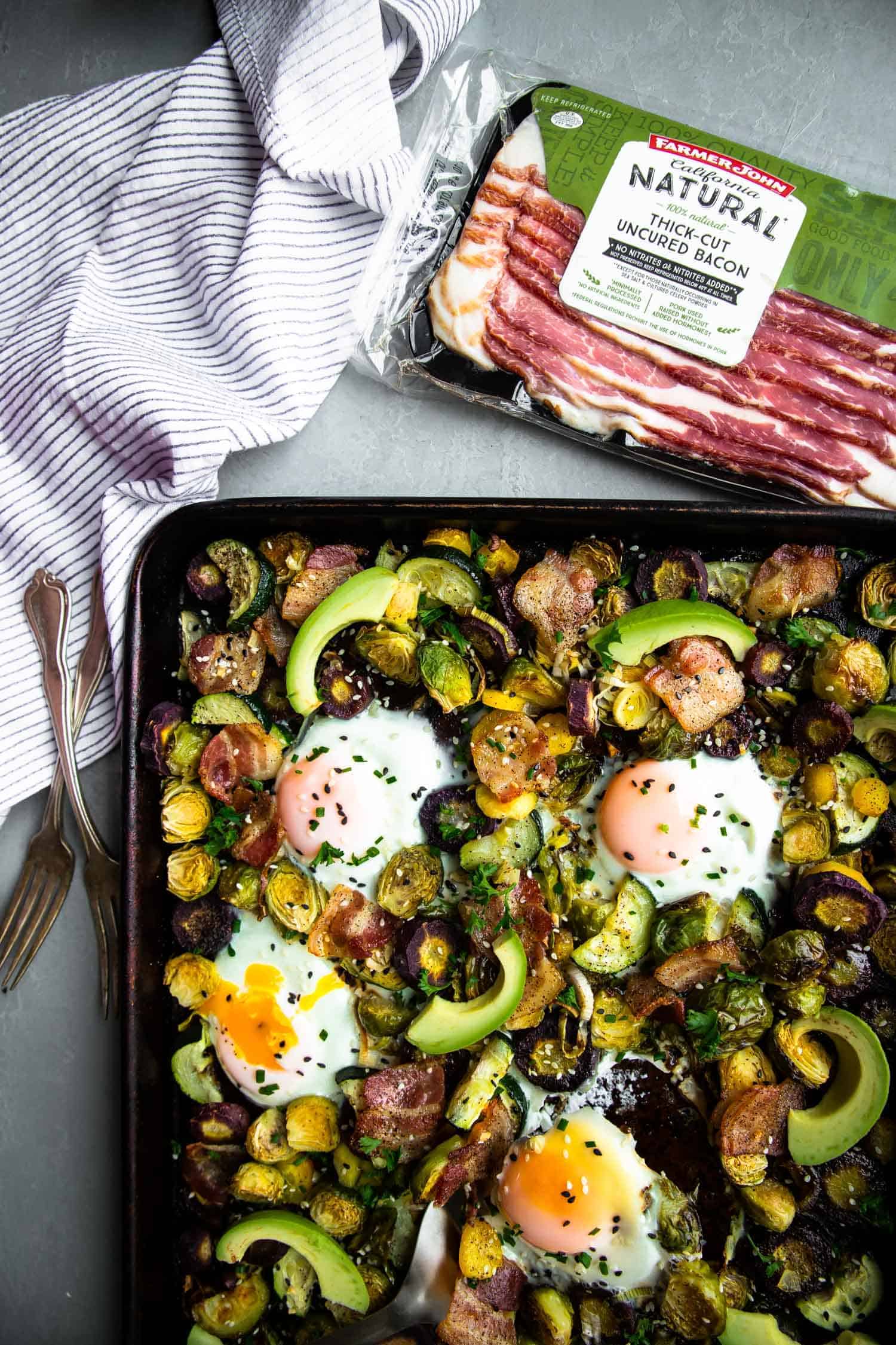 eggs, bacon, avocado and vegetables  in a sheet pan